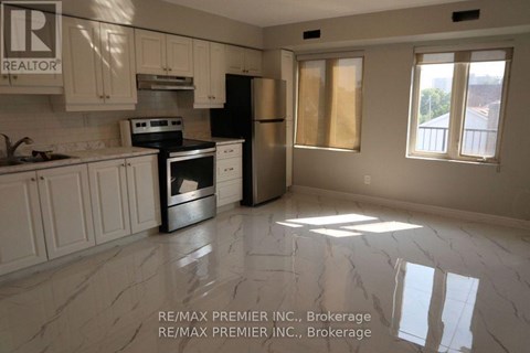A kitchen with white cabinets and a black stove top oven.