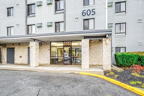 The image shows the front of a building with the number 605 on it.