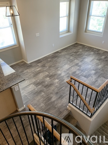 A living room with a staircase leading to the upper floor.
