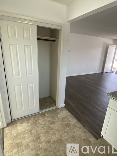 A room with a white door and a tiled floor.