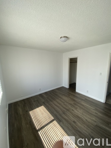 A room with wooden floors and a white ceiling.
