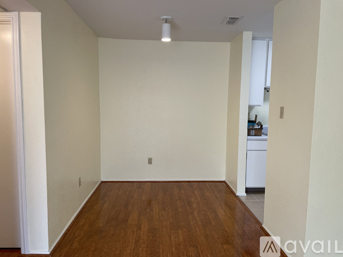 A room with wooden floors and white walls.