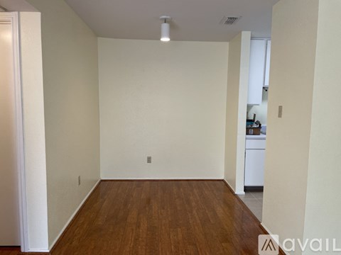 A room with wooden floors and white walls.