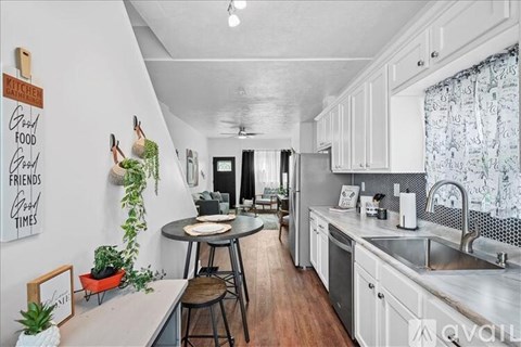 A kitchen with a table and chairs in the middle of the room.