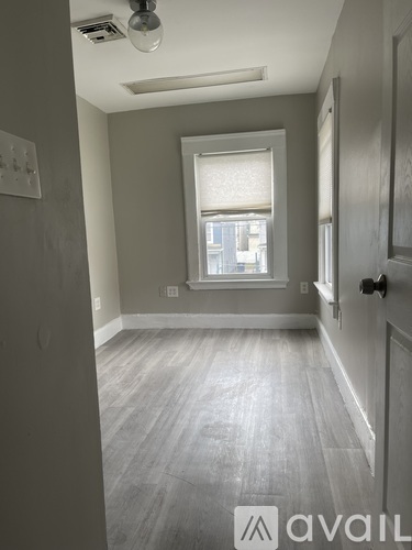 A room with a window and a door.