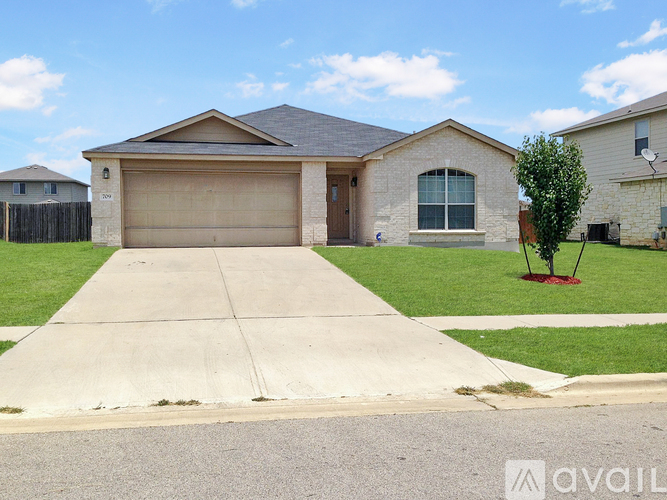 A house with a garage and a driveway is for sale.