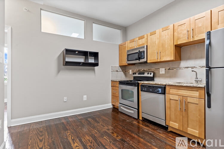 A kitchen with wooden cabinets and stainless steel appliances.