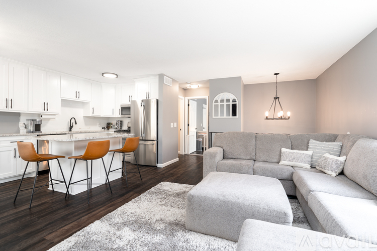 A modern kitchen with a dining table and chairs.