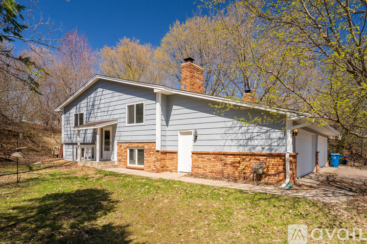 A house with a blue exterior and a chimney is for sale.