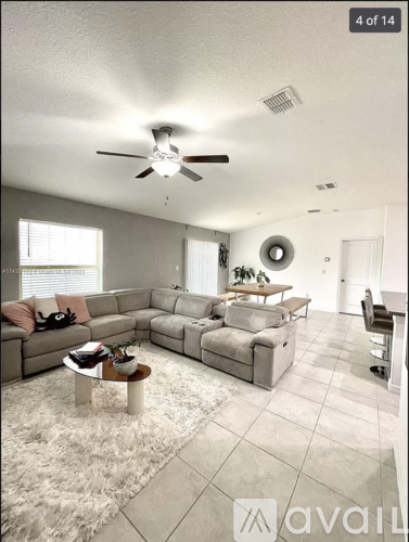 A living room with a grey couch and a coffee table.