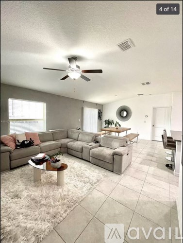 A living room with a grey couch and a coffee table.