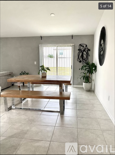 A dining room with a table and bench.