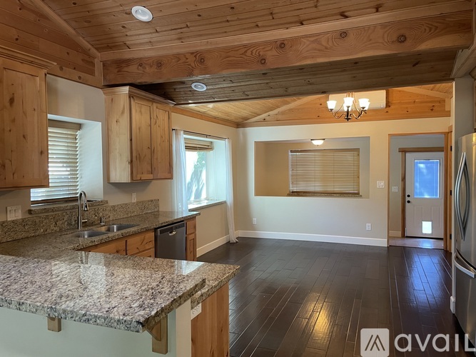 A kitchen with wooden cabinets and granite countertops.