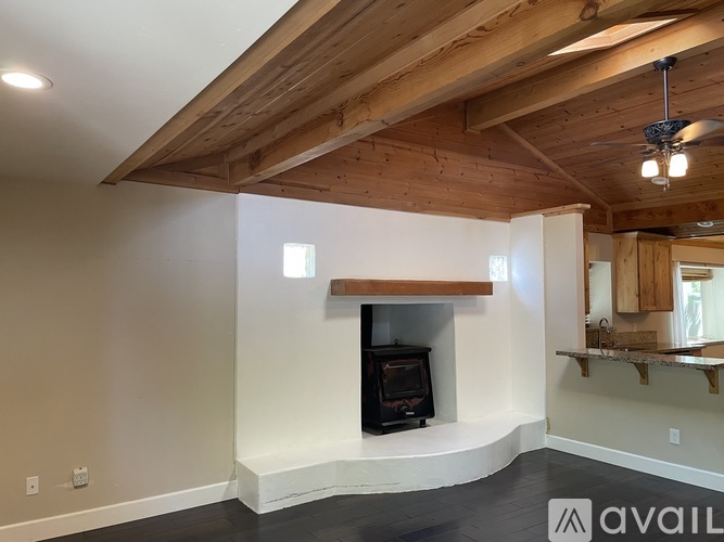 A room with a wood burning stove in the corner.
