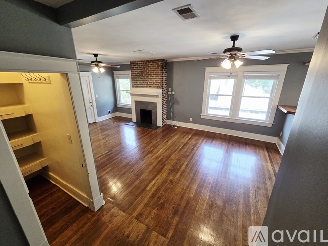 A room with a fireplace and a ceiling fan.