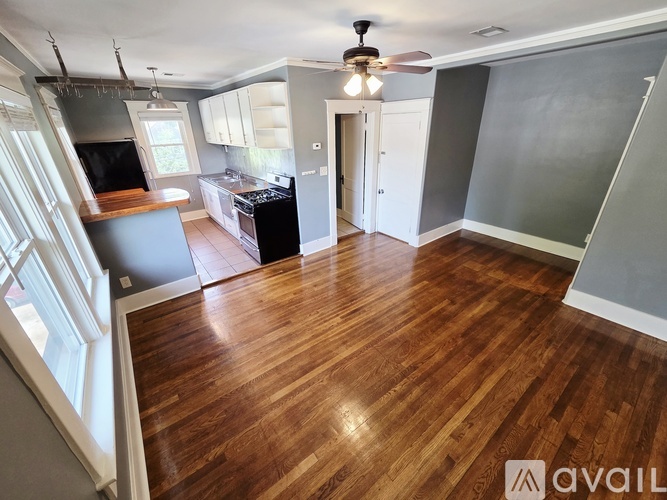 A kitchen with a black stove top oven and white cabinets.