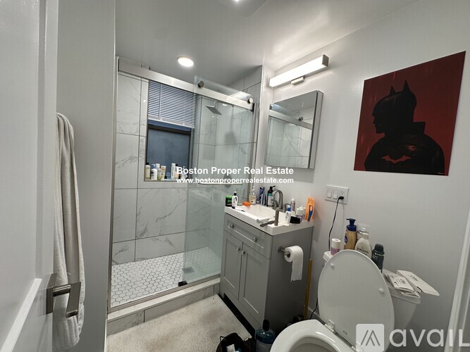 A bathroom with a toilet, sink, and shower.