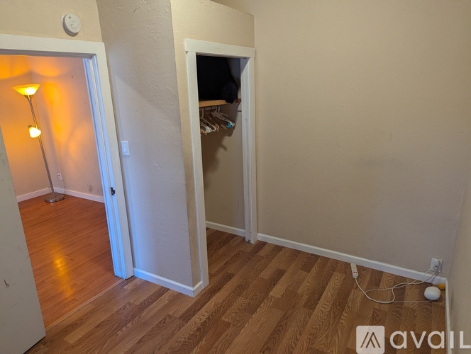 A room with a wooden floor and a white door.