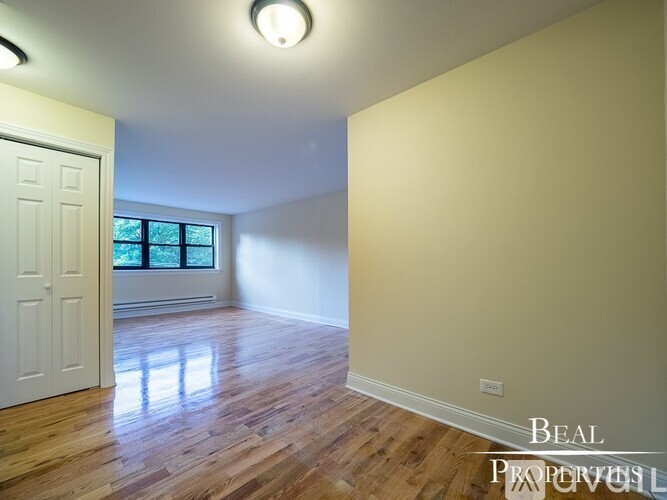 A room with wooden floors and a white door.