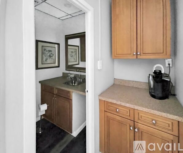 A kitchen with wooden cabinets and a marble countertop.