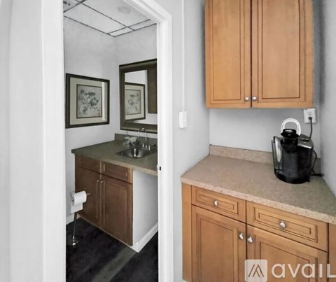 A kitchen with wooden cabinets and a marble countertop.