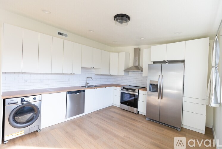 A kitchen with white cabinets and stainless steel appliances.