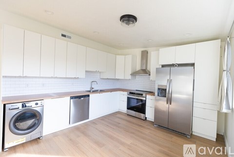 A kitchen with white cabinets and stainless steel appliances.
