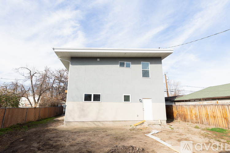 A two-story house with a grey and white exterior is for sale.