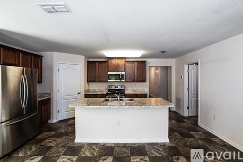 A kitchen with a checkered floor and a white island.