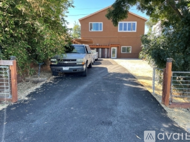A house with a driveway and a parked truck.