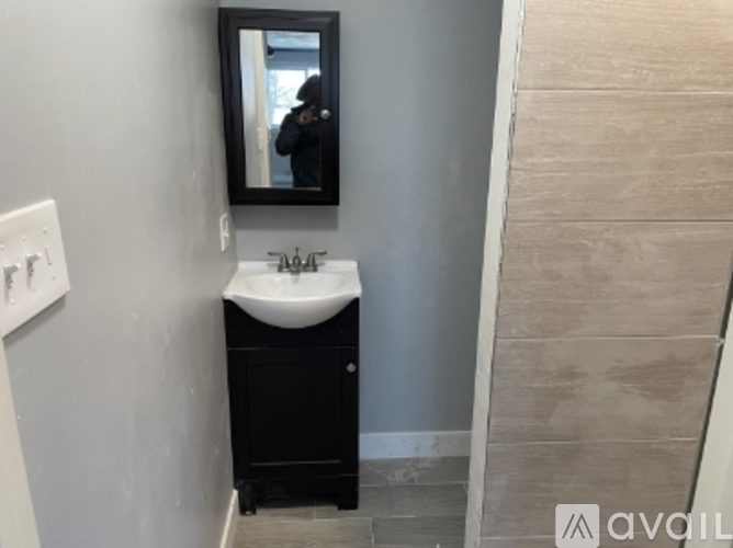 A bathroom with a sink and mirror.