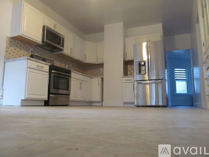 A kitchen with white appliances and cabinets.