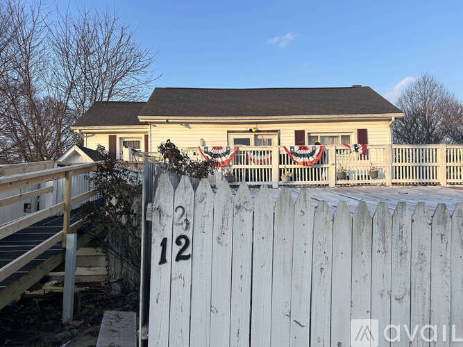 A white picket fence with the number 12 on it.