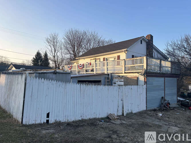 A house with a white fence in front of it.