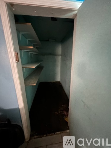 A room with a staircase and a black object on the floor.