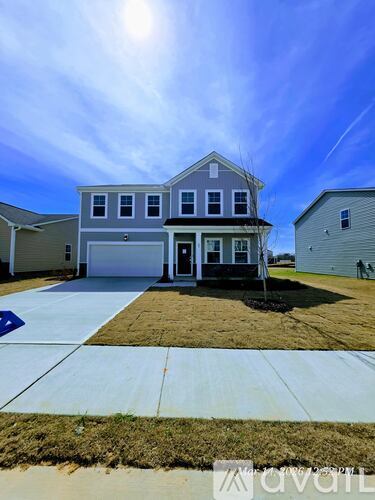 A two-story house with a garage is shown in the image.