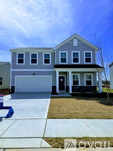 A two-story house with a garage is for sale.