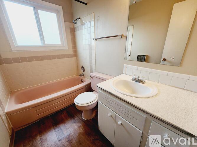 A bathroom with a toilet, sink, and bathtub.