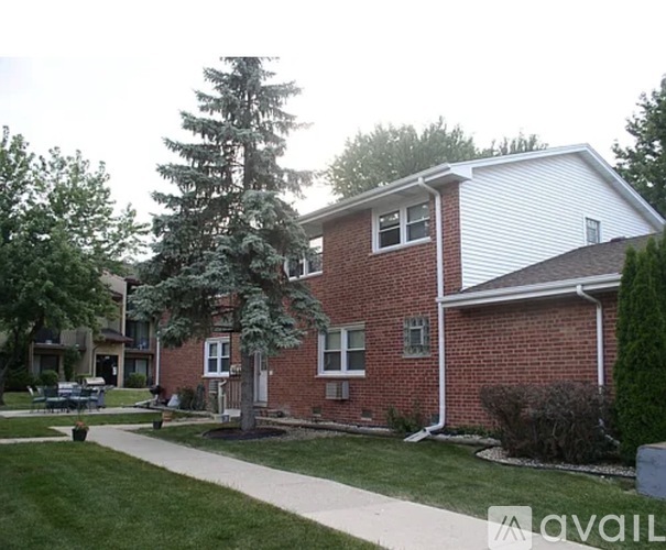 A house with a red brick exterior and a white roof.
