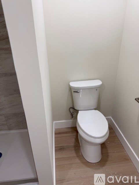 A white toilet in a small bathroom.