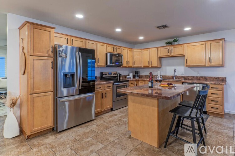 A kitchen with wooden cabinets and a granite countertop.