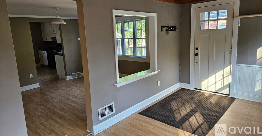A room with a window and a door is shown.