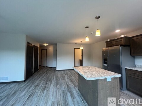 A kitchen with a countertop and cabinets is shown.
