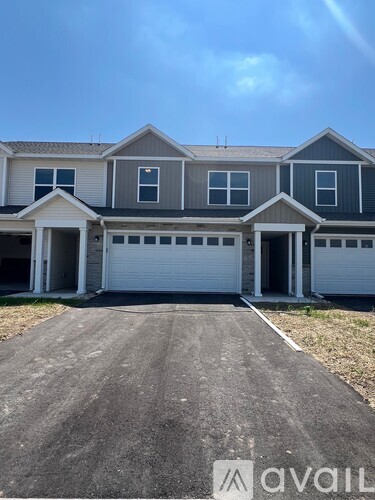 A two-story house with a garage is available for rent.