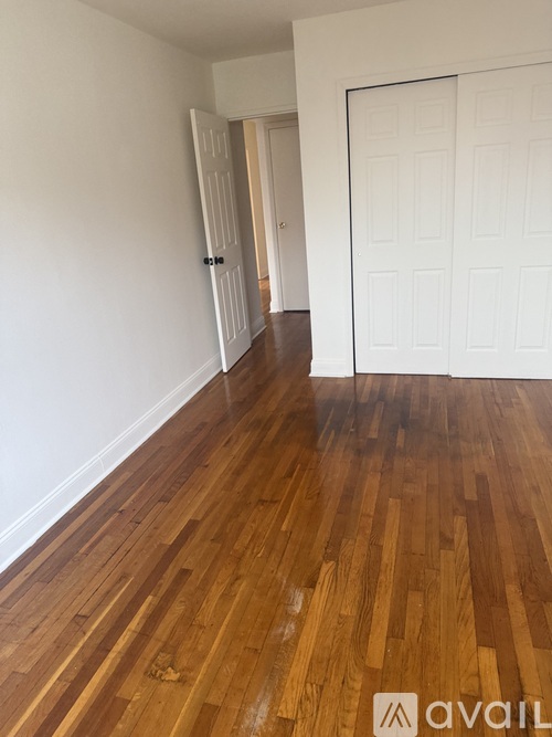 A room with wooden floors and white walls.