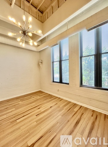 A room with wooden floors and a ceiling fan.