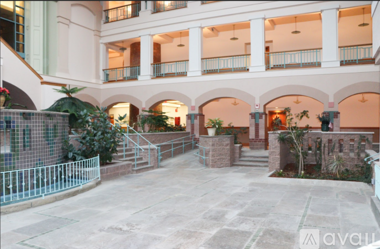 A courtyard with a fence and plants.