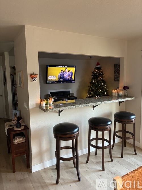 A living room with a bar and a Christmas tree.