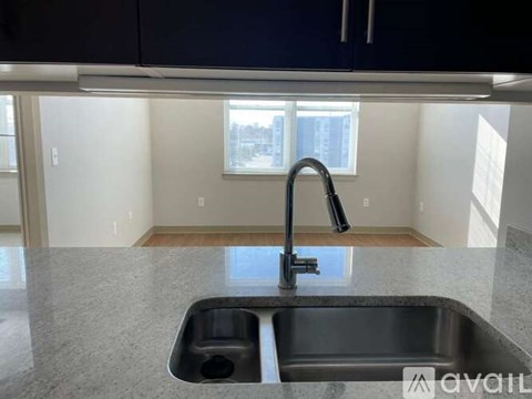 A kitchen with a sink and a window.