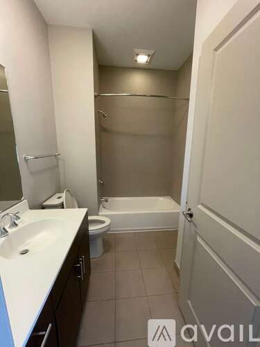 A bathroom with a toilet, sink, and bathtub.